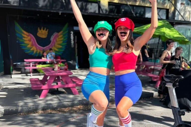 two young women pose in their Mario and Luigi halloween costumes in tampa bay