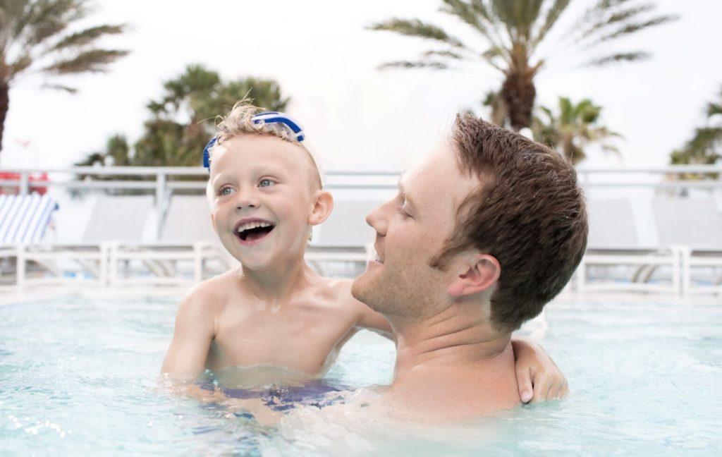 Father's Day events in Tampa Bay - Father splashing with son in a pool