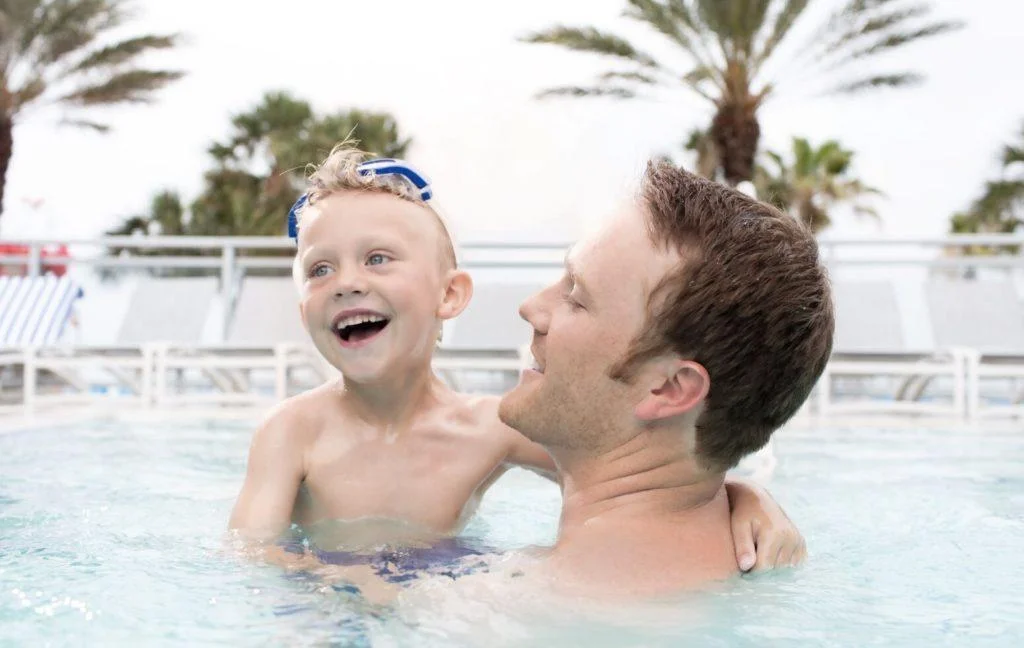 Father's Day events in Tampa Bay - Father splashing with son in a pool