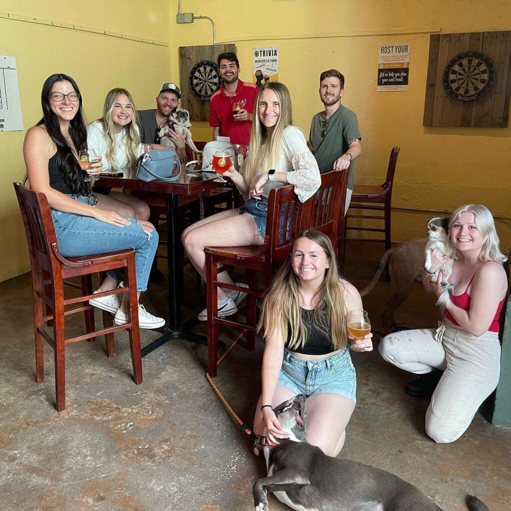 a group of friends and their dogs gather at Pinellas Ale Works St. Pete Brewery