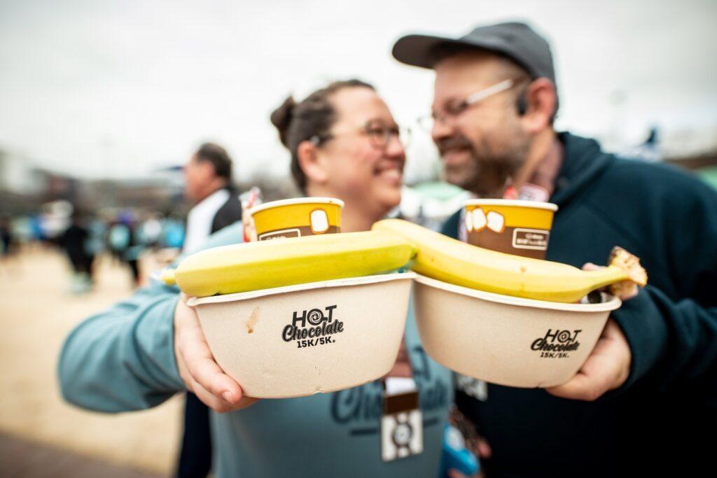 couple poses with Hot Chocolate Run post-race treats