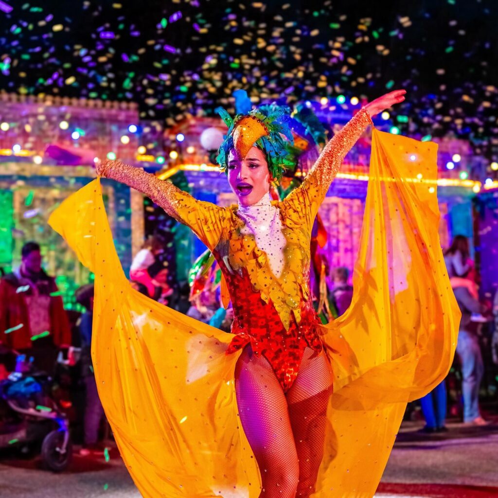 Busch Gardens Mardi Gras performer in parade with flowy costume - @buschgardens