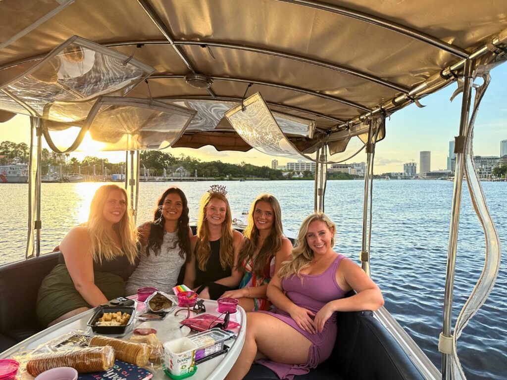 Group of young ladies on an e-boat at Tampa Riverwalk celebrating a birthday