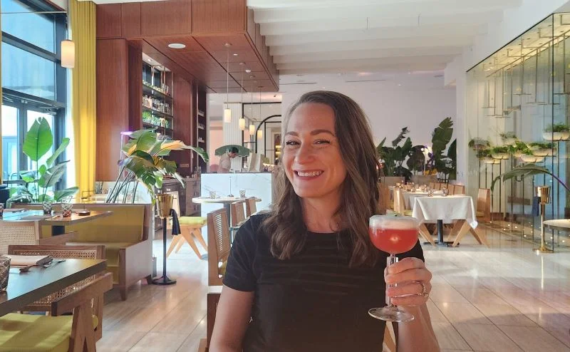 Woman drinking a cocktail for Magical Dining at Salt & the Cellar by Akira Back