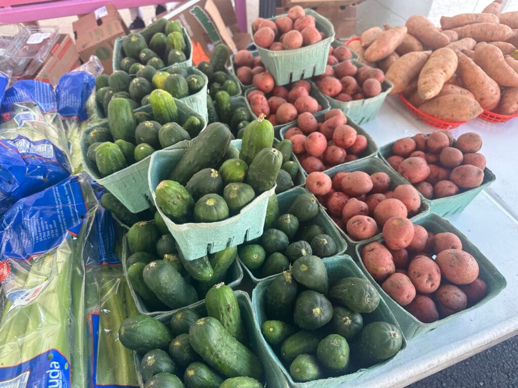 Cucumbers, potatoes and celery for sale from a vendor at the Fresh Market at Wiregrass.