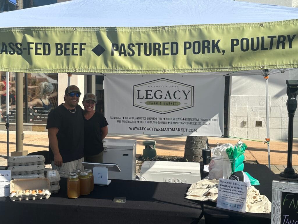 Legacy Farm and Market Booth selling beef, pork, and poultry at the Fresh Market at Wiregrass.