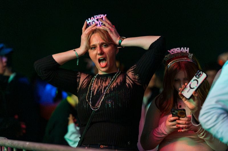 woman enjoying fireworks and party at St. Pete Pier NYE 2024 - Chris Fasick Photography-8