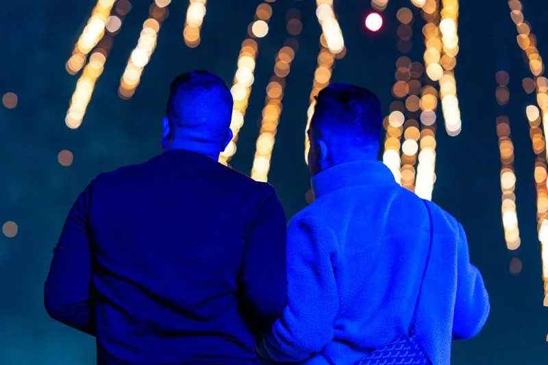 a romantic couple enjoys fireworks at St Pete Pier for new year eve
