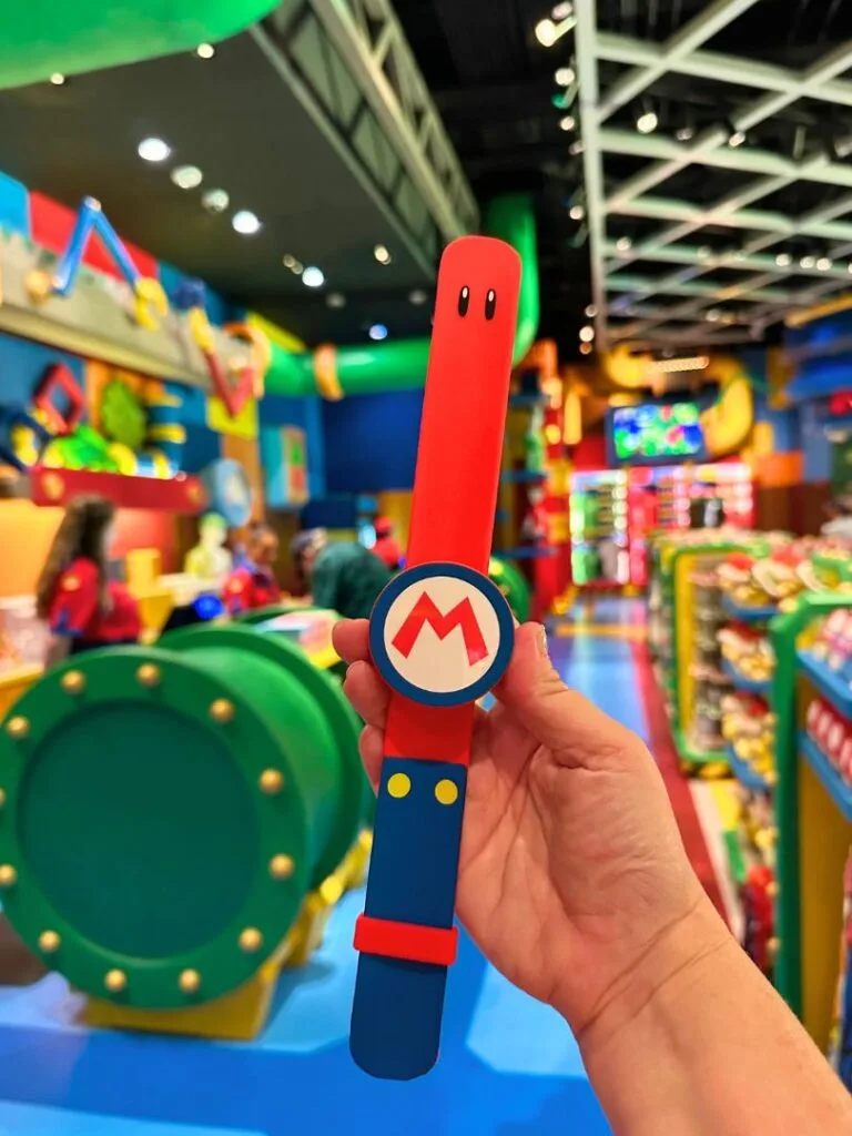 Photographer holding up Mario Power-Up Band for Super Nintendo World at Epic Universe - image by Dani Meyering