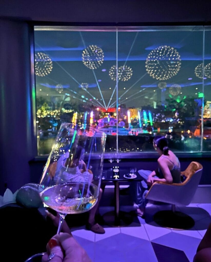 GEO-82 Adults Only Lounge at EPCOT dining area with view of EPCOT Fireworks with champagne - image by Dani Meyering compress