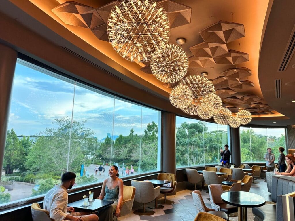 GEO-82 Adults Only Lounge at EPCOT guests in dining area daytime view - image by Dani Meyering (with cameo of @roamsick)