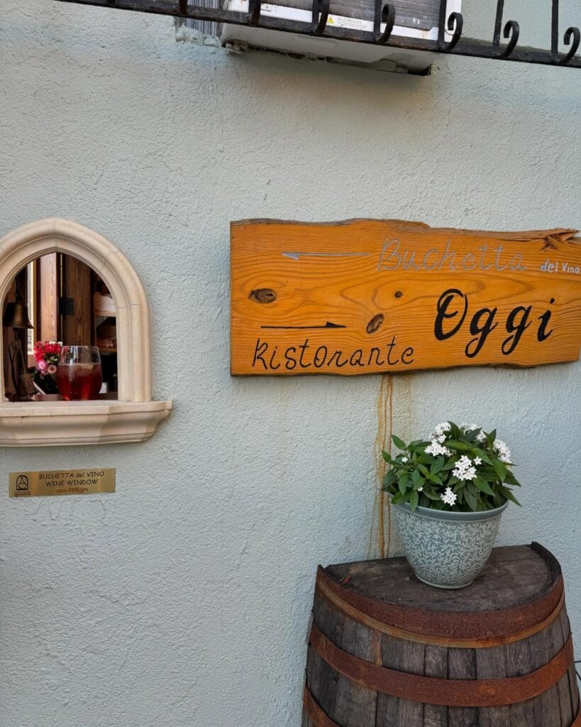Oggi Spritz Bar Wine Window Tampa Bay 2 with barrel, flowers, and sign