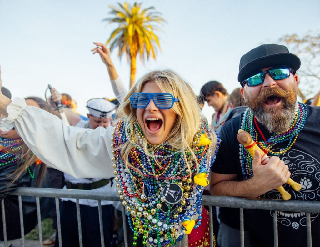 Paradegoers collect a bunch of beads at the parade, which is the only way to get beads!