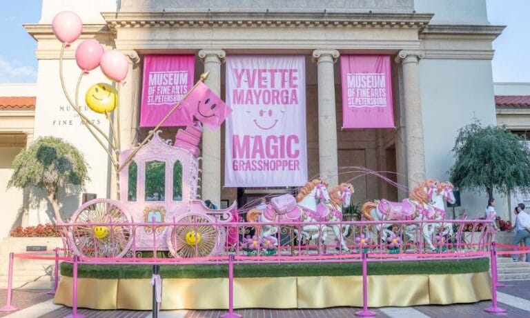 A 30-foot long house and carriage sculpture by Yvette Mayorga outside of the Museum of Fine Arts in St. Pete Florida