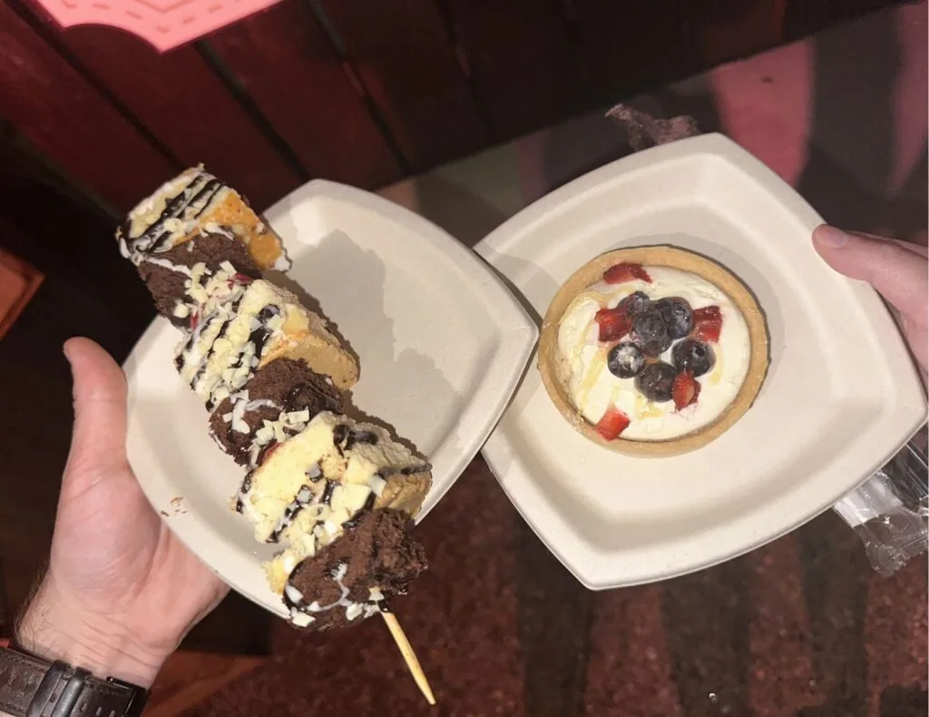 a small tart and giant strawberry shortcake kabob on a dark wooden background Food Wine & Garden Festival