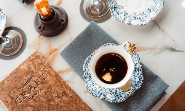 A cup of tea with a Craft river cruise menu for tea service in Tampa Bay