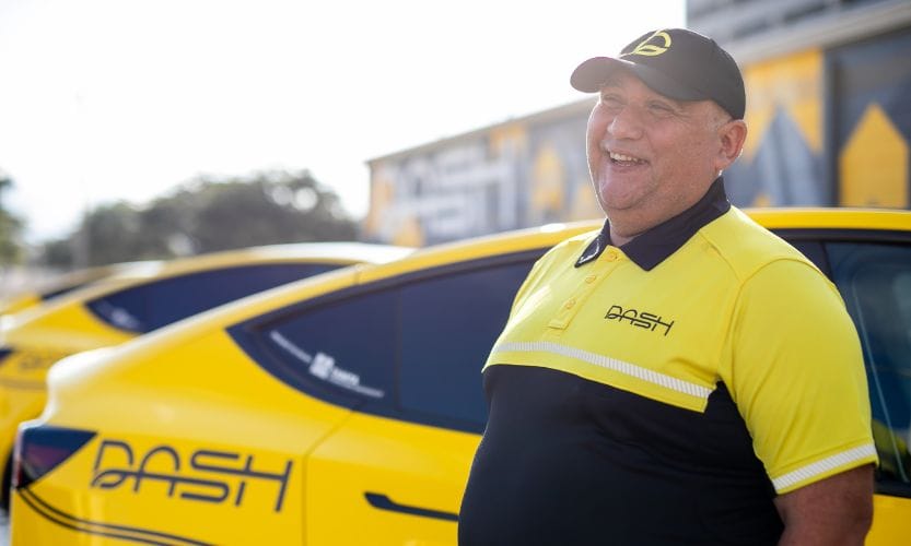 DASH yellow car and driver posing for a photo