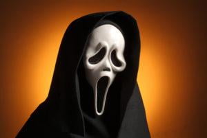 scream mask in front of orange background, from istock